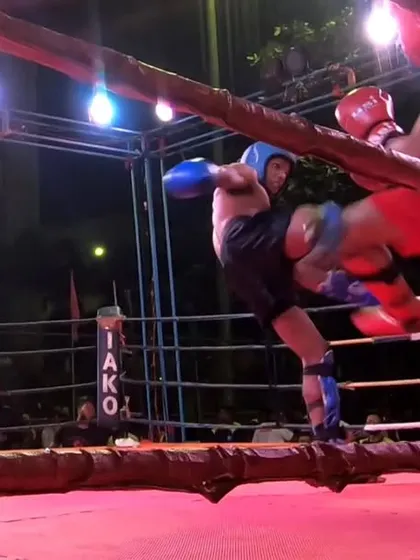 A defensive kick keeps the opponent at a distance during a heated exchange.