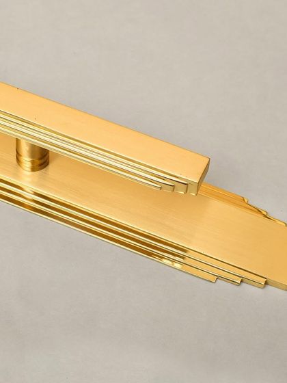 The Natali pull with its long backplate, demonstrating how the design can be extended to create a more dramatic and elongated statement on a tall door.