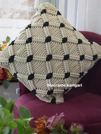 A detailed shot of the knotwork on our macramé cushion cover. This piece is a testament to the skill and patience that goes into our handmade decor.