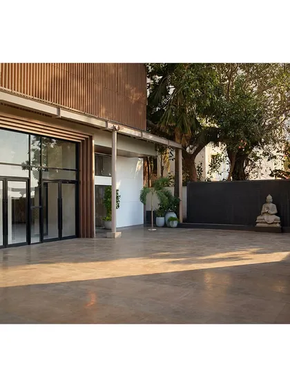 The spacious outdoor patio provides a versatile area for pre-event gatherings, with a new water feature and clean, modern surfaces.