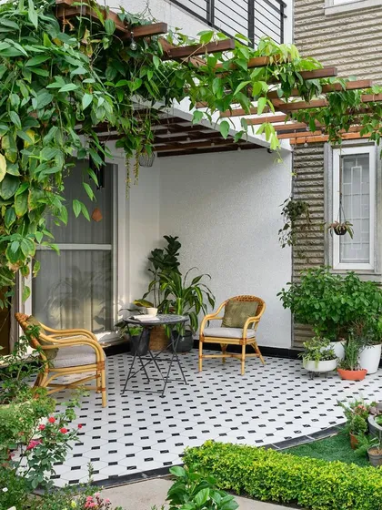 We extend our design philosophy to outdoor spaces, creating tranquil retreats like this garden for the 'House of Kismish'. The patterned flooring and a lush trellis create a serene setting, perfect for enjoying a quiet morning or a peaceful evening.