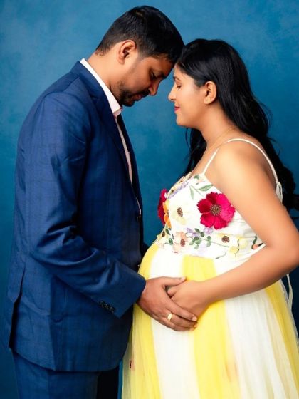 An intimate and loving moment between a couple, perfectly capturing the anticipation of parenthood.