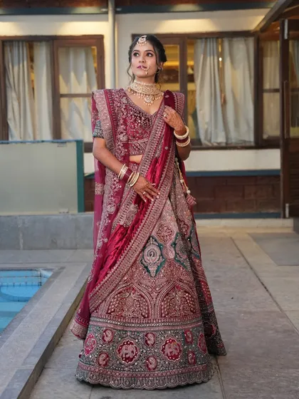 For a grand reception, a bride deserves to feel like royalty. I designed this full-glam look to match the opulence of her deep red velvet lehenga, ensuring she was the star of the evening.