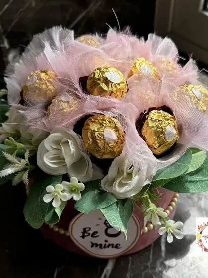 This Ferrero Rocher chocolate bouquet is a popular choice for engagements and anniversaries. I arrange the chocolates with delicate artificial flowers and soft netting in a velvet-finish box, creating an elegant and delicious gift.