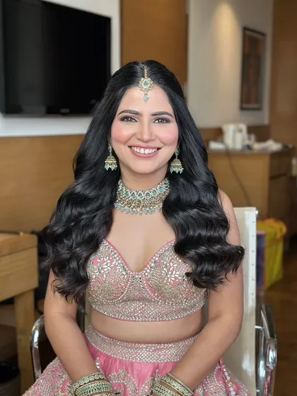 A happy engagement bride with a simple half-up style and beautiful, healthy-looking waves.
