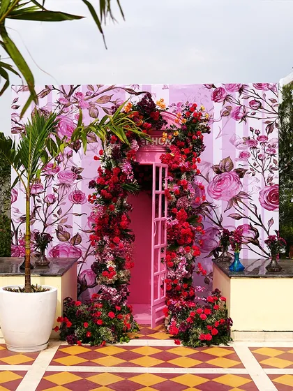 A whimsical floral entrance at the Hyatt Regency Jaipur. The pink door surrounded by a cascade of red and pink flowers creates a magical photo opportunity.
