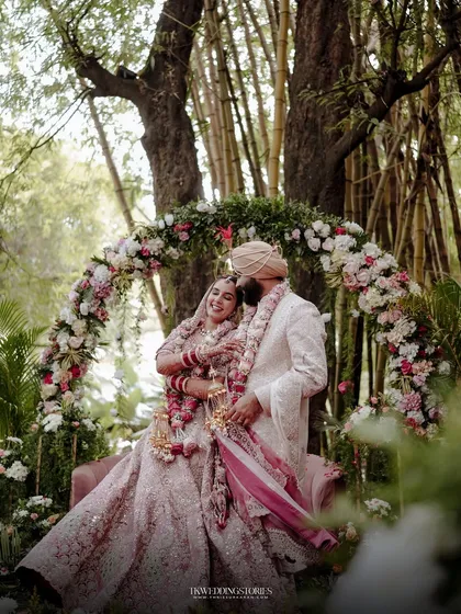 A fairytale moment for a Punjabi couple, framed by a stunning floral arch in a lush Bangalore garden. This shot showcases my approach to creating grand, yet intimate, wedding portraits.