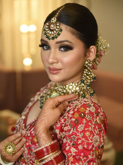 This bride's confidence shines through, enhanced by a statement Kundan choker and matching tikka. It's a powerful look for the modern bride.