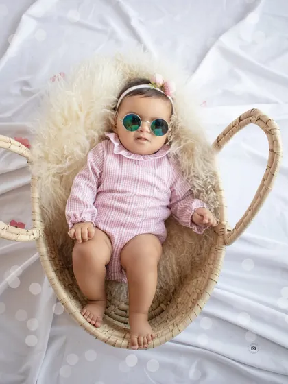 This little one is too cool. A fun shot from a six-month session, complete with a pink outfit and stylish sunglasses.