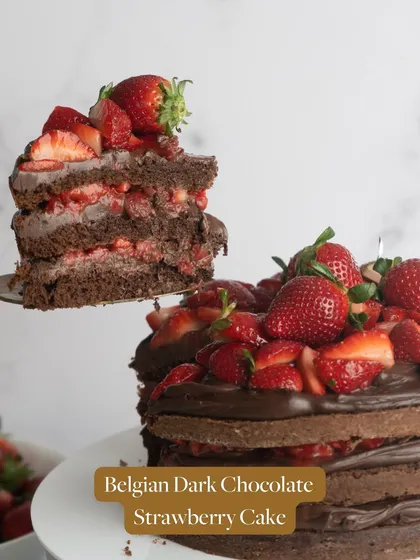 A slice of my Belgian Dark Chocolate Strawberry Cake, lifted to show the rich layers inside. It's a perfect balance of deep chocolate flavor and sweet fruit.