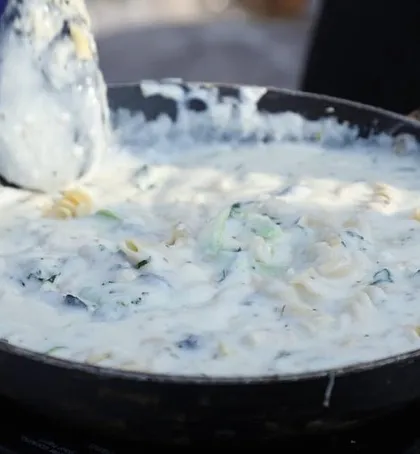 A close-up of a creamy and delicious white sauce pasta being prepared at one of our live counters. We use quality ingredients to ensure every dish is rich and satisfying.