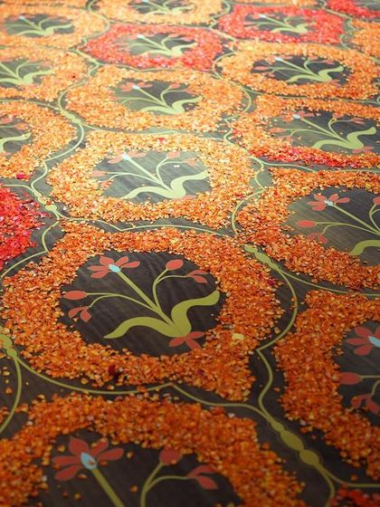 The floor of the mandap was a work of art in itself, with a pattern created from thousands of hand-placed orange flower petals.