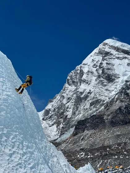This is what it feels like to be on the edge of the world. Here, a climber practices rappelling on a sheer ice wall near Everest Base Camp, with the magnificent peak of Pumori standing guard. It's in these moments of intense focus, surrounded by raw beauty, that you find out what you're truly made of.