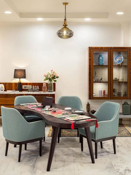 The bean-shaped dining table at our Ridge View project defies convention, adding a sense of spontaneity and movement. Designed to be a hub for interaction, it flows seamlessly into the rest of the home, creating an airy, connected environment for shared experiences.