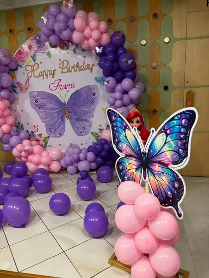 Another view of Aarvi's butterfly birthday backdrop, with an Ariel doll prop adding a touch of extra magic.