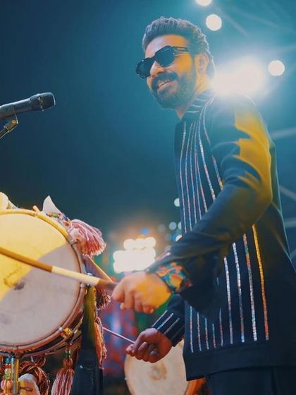 Fashion meets finesse on stage. Our custom-made striped jacket and kurta set, designed for performance and style, seen here in its element.