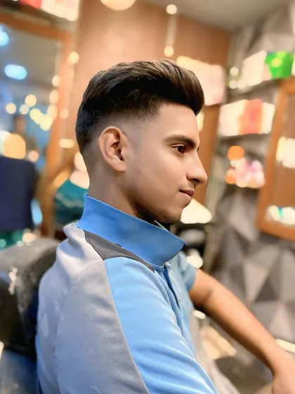 A profile shot that showcases the clean silhouette of the high fade and the height of the styled hair on top.