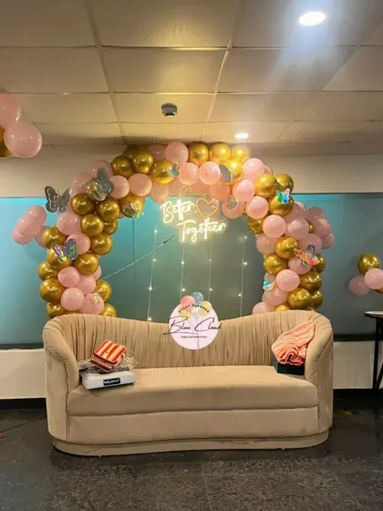 A romantic 'Better Together' setup with a pink and gold balloon arch, perfect for an anniversary or engagement party.