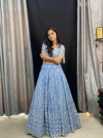 Another angle of the beautiful powder blue lehenga, showing off the full skirt and its delicate silver embroidery.