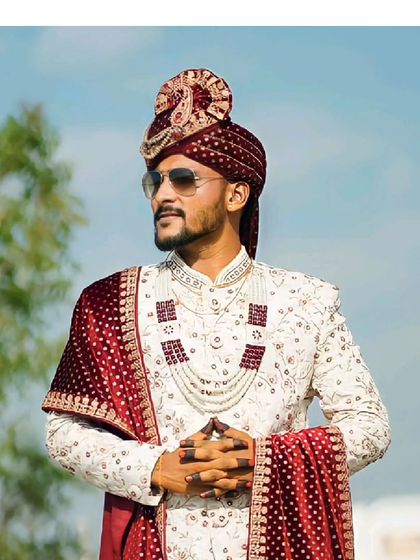 Another shot of our client looking like royalty in the classic cream sherwani, complete with safa and sunglasses. A perfect look for a grand entrance.
