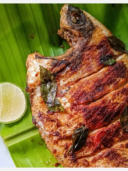 I source my Karimeen, or Pearlspot, from the wild backwaters of Vembanad Lake in Kerala to ensure the best taste. I prepare it simply by tawa-grilling it with a salt and chilli rub in curry leaf-seasoned coconut oil, letting the fish's natural flavour shine.
