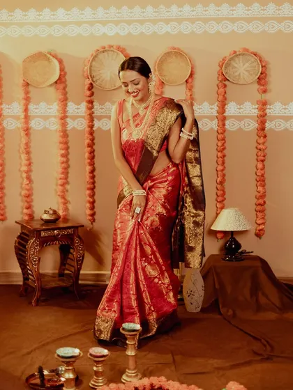 A full-length shot showing the entire Diwali setup in my studio, with marigold decorations and diyas. The model's candid smile makes the shot feel authentic and joyful.