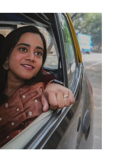 A simple, beautiful shot of her looking out of a classic Mumbai taxi window, capturing a moment of quiet reflection during our day of shooting.