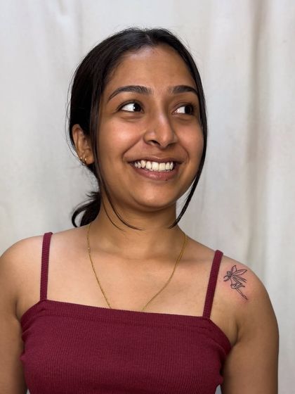 The client showing off her new fairy tattoo on her shoulder.