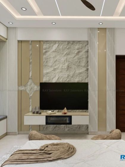 A view of the TV unit in the bedroom, which is set against a stone and wood-paneled wall.