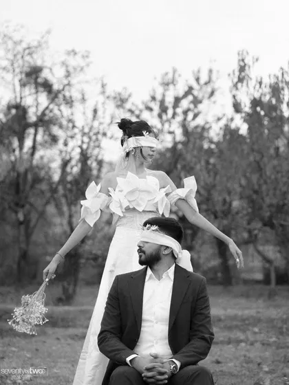 A playful, almost dance-like pose from their conceptual shoot. It shows that even within a serious artistic concept, their joyful personalities shine through.