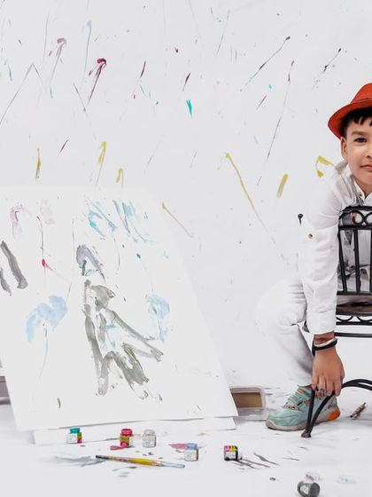 A thoughtful pose from the painter-themed session, as the young artist takes a break on his stool.