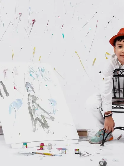 A thoughtful pose from the painter-themed session, as the young artist takes a break on his stool.