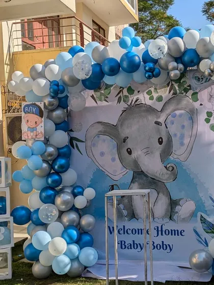 This outdoor setup shows how I can adapt my decorations for any space, like a lawn or backyard. The "BABY" boxes and balloon arch create a complete photo zone.