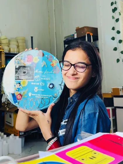 A smiling photo of me with the completed baby keepsake frame. These projects always bring me so much joy.