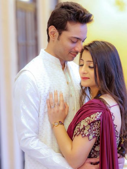 A romantic and intimate pre-wedding moment. The makeup is soft and natural, enhancing her features for this close-up shot.