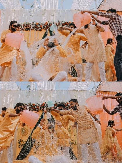 The groom gets a surprise drenching with buckets of water from his friends, a hilarious and memorable haldi moment.