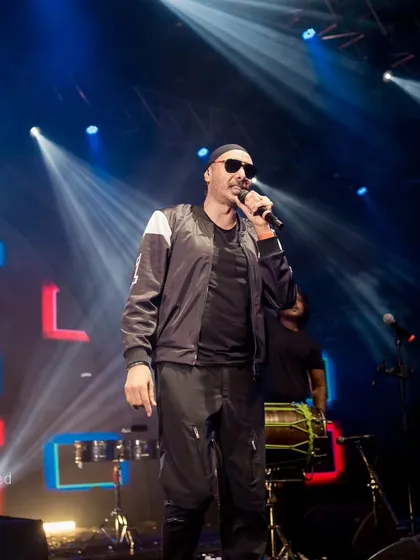 Sukhbir commanding the stage with his signature energy. We design the production to match the artist's high-octane performance style.