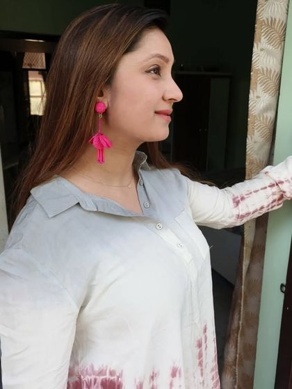 A side profile of me wearing the gorgeous hot pink drop earrings, showing how they dangle.
