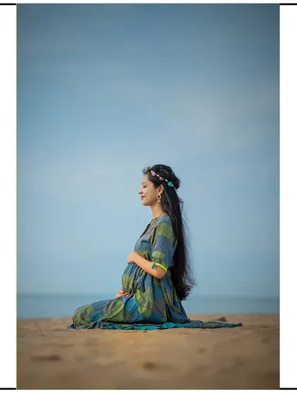 A peaceful moment of meditation on the beach, connecting with the baby and the sound of the waves.