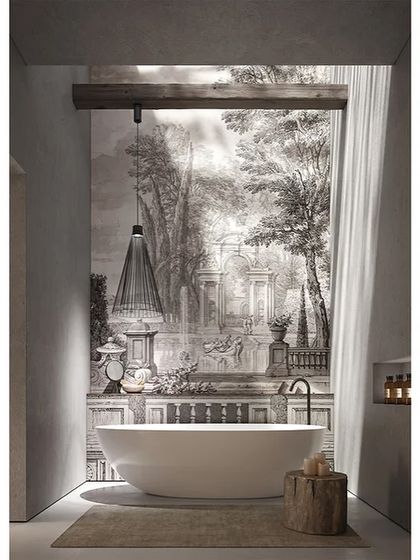 A single Ikonika pendant hangs over a freestanding bathtub, its industrial-chic design adding a touch of modern elegance to the luxurious bathroom.