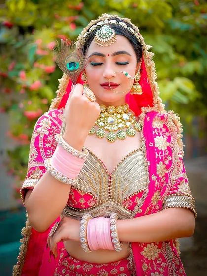 An outdoor close-up focusing on the bride's serene expression and traditional jewelry, with a soft, natural background.