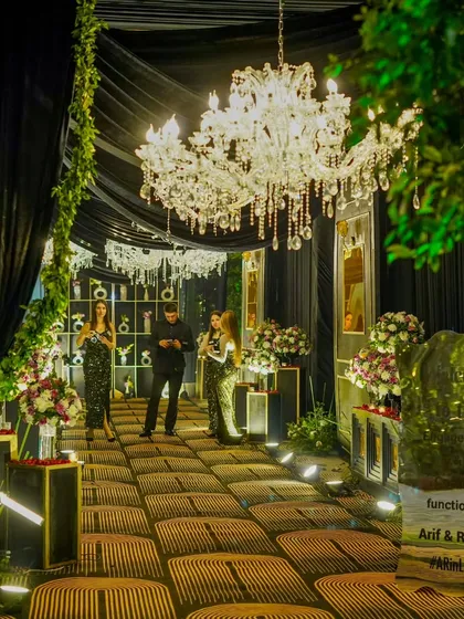 Guests mingling within the stunningly decorated entryway, showcasing the scale and immersive quality of our event designs.