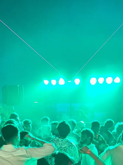 A sea of people under the green lights. This is a classic dance floor moment from one of my festival sets. My goal is to make you lose yourself in the music, just like this.