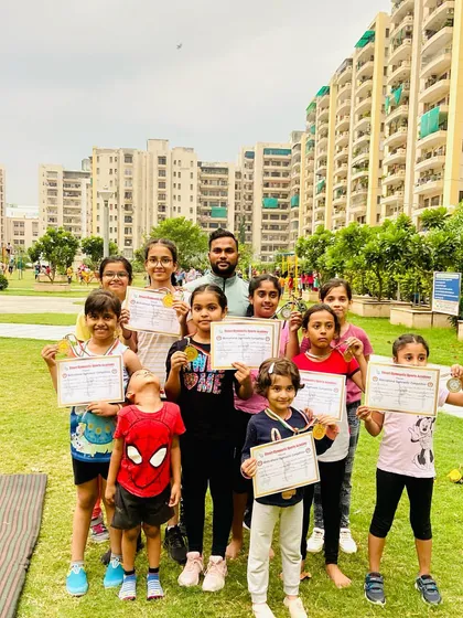 Seeing my students succeed is the best reward. Here is a group of our young champions proudly showing off the medals and certificates they earned after a competition, a result of their hard work and dedication in our outdoor classes.