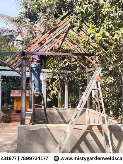 Another angle of the cow shed's steel frame construction. The pitched roof design is engineered for strength and to support the traditional thatched roofing material.