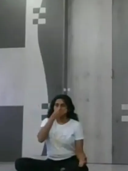 An instructor demonstrates a pranayama technique during our evening online yoga class. Clear visual guidance is a key component of our virtual sessions.