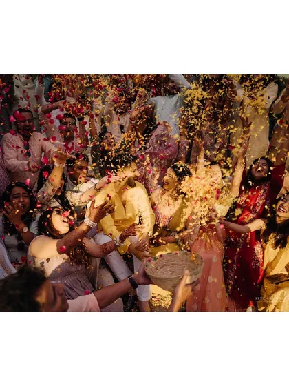 A shower of love and petals. This is the beautiful chaos of a haldi ceremony, a moment of pure euphoria that I love to capture. The air is filled with marigold petals, laughter, and celebration.