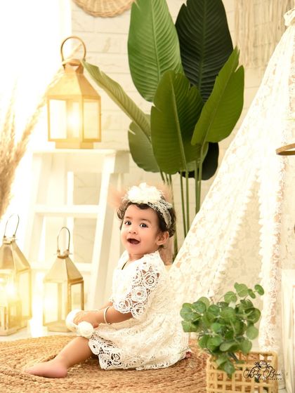 A happy wave from our boho camp. The warm lanterns and natural props create a cozy and inviting scene for her first birthday photos.