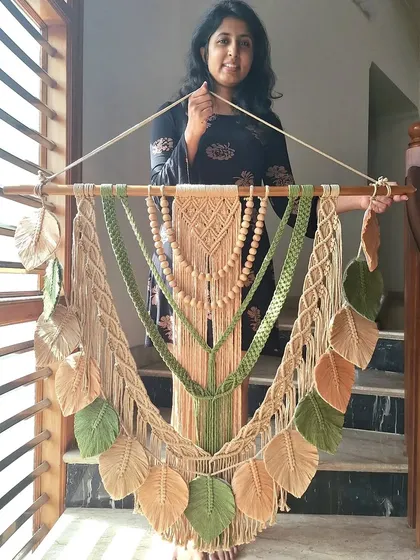 We crafted this custom macrame wall hanging with earthy green and beige tones to perfectly match our client's wall. It's a one-of-a-kind piece that blends textures and colors in beautiful harmony.