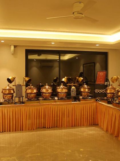 Another angle of the extensive buffet setup for a housewarming party, showcasing the scale and professionalism I bring to indoor events. The warm lighting highlights the beautiful copper pots.